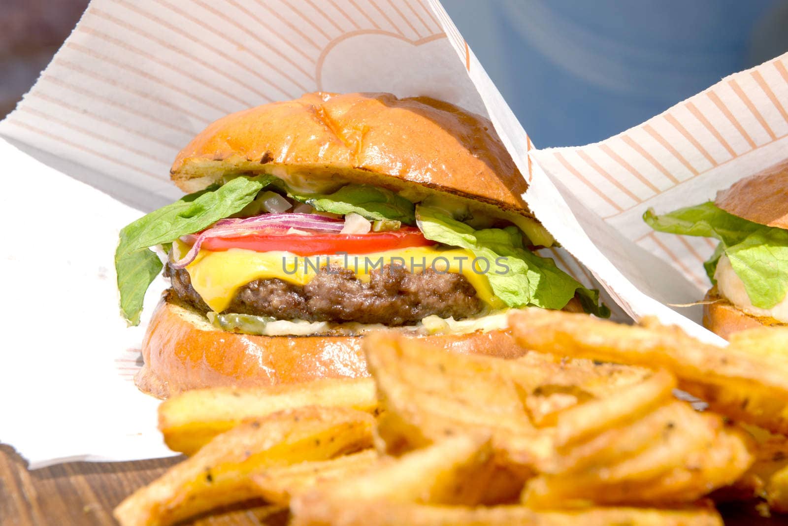 fresh burgers and fries on a wooden tray