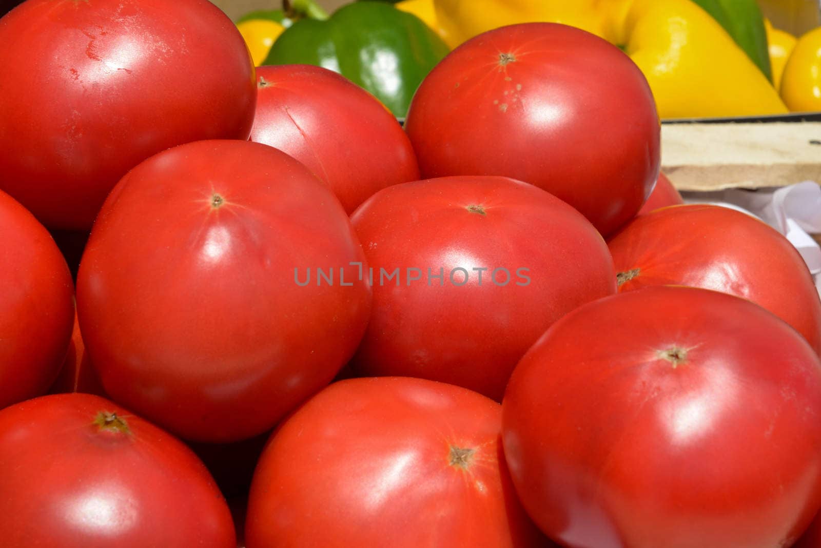 lot of ripe tomatoes in wooden crates close up