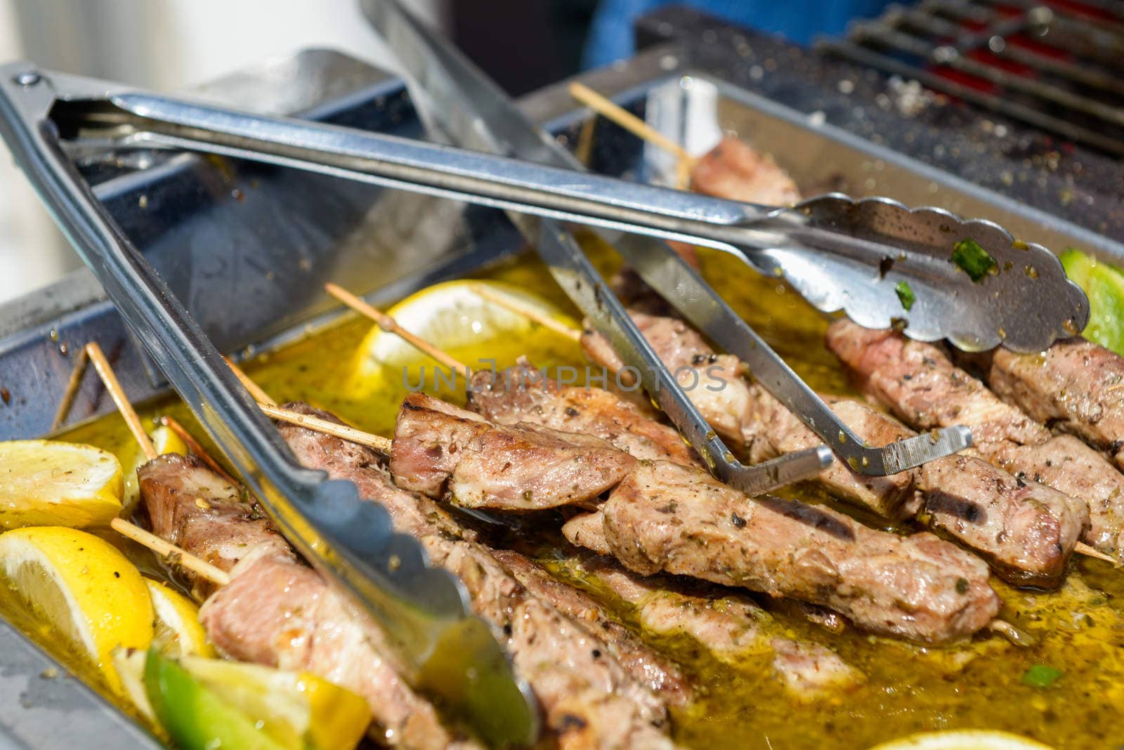 Juicy roasted kebabs on the metal tray by vlaru