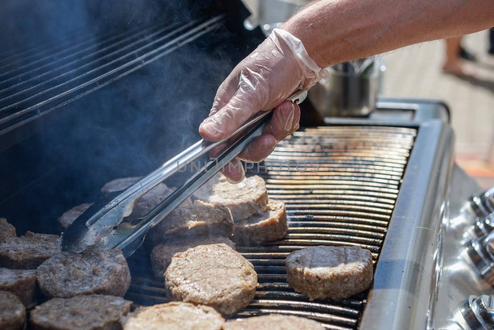 cooking steaks on a hot grill in a summer day