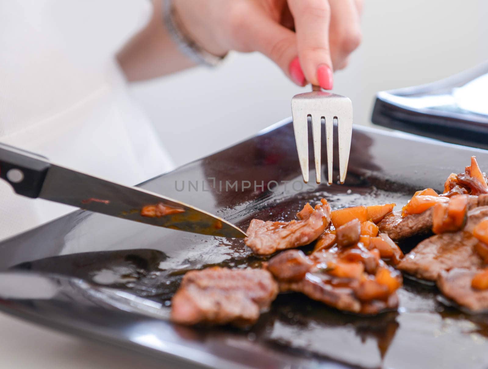 delicious freshly cooked dish of pork with sauce on the black plate