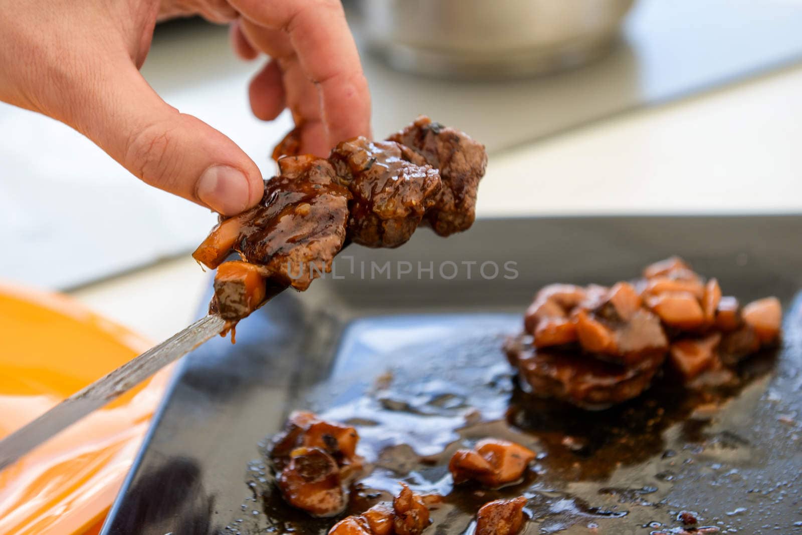 delicious freshly cooked dish of pork with sauce on the black plate