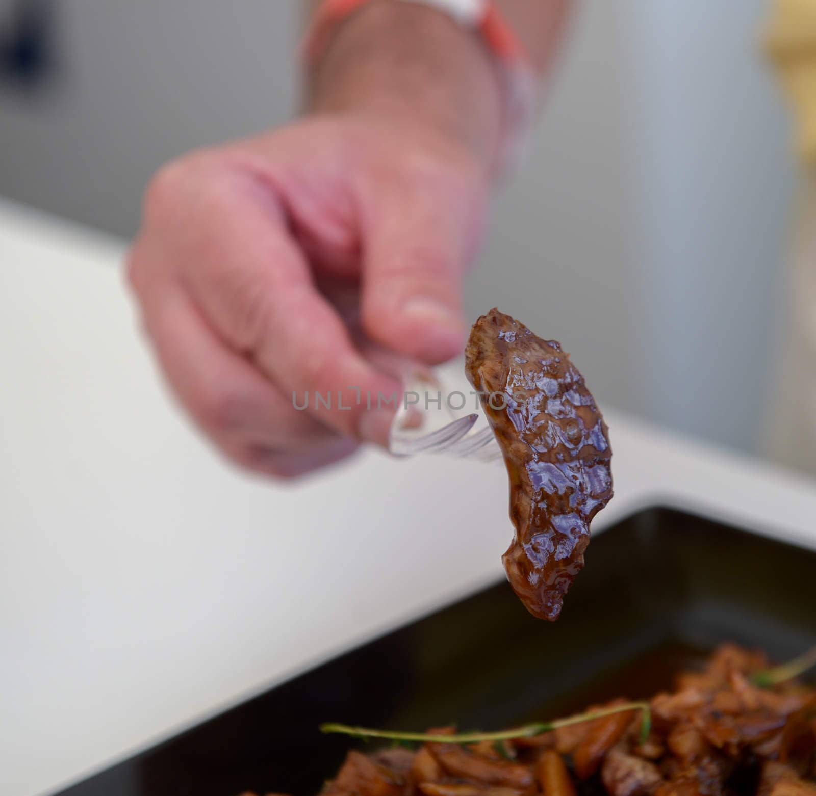 delicious freshly cooked dish of pork with sauce on the black plate