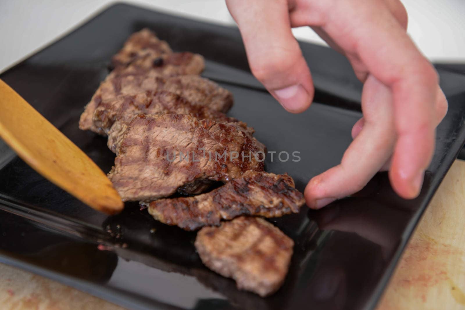 Delicious juicy steak on a black square plate