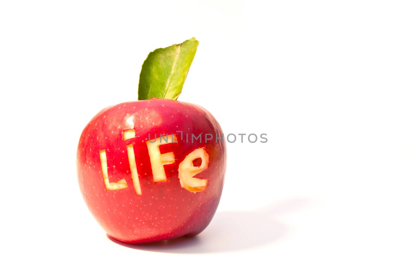 word of life cut out on a red apple