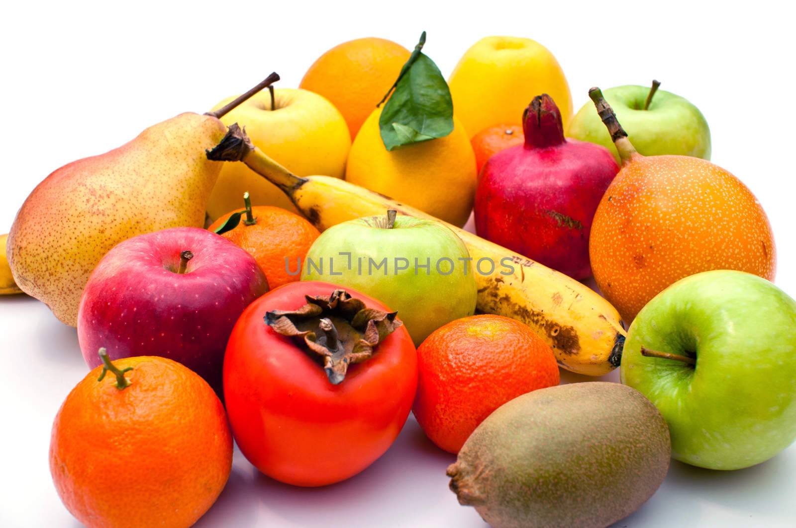 a lot of different fruits and green leaves on white background