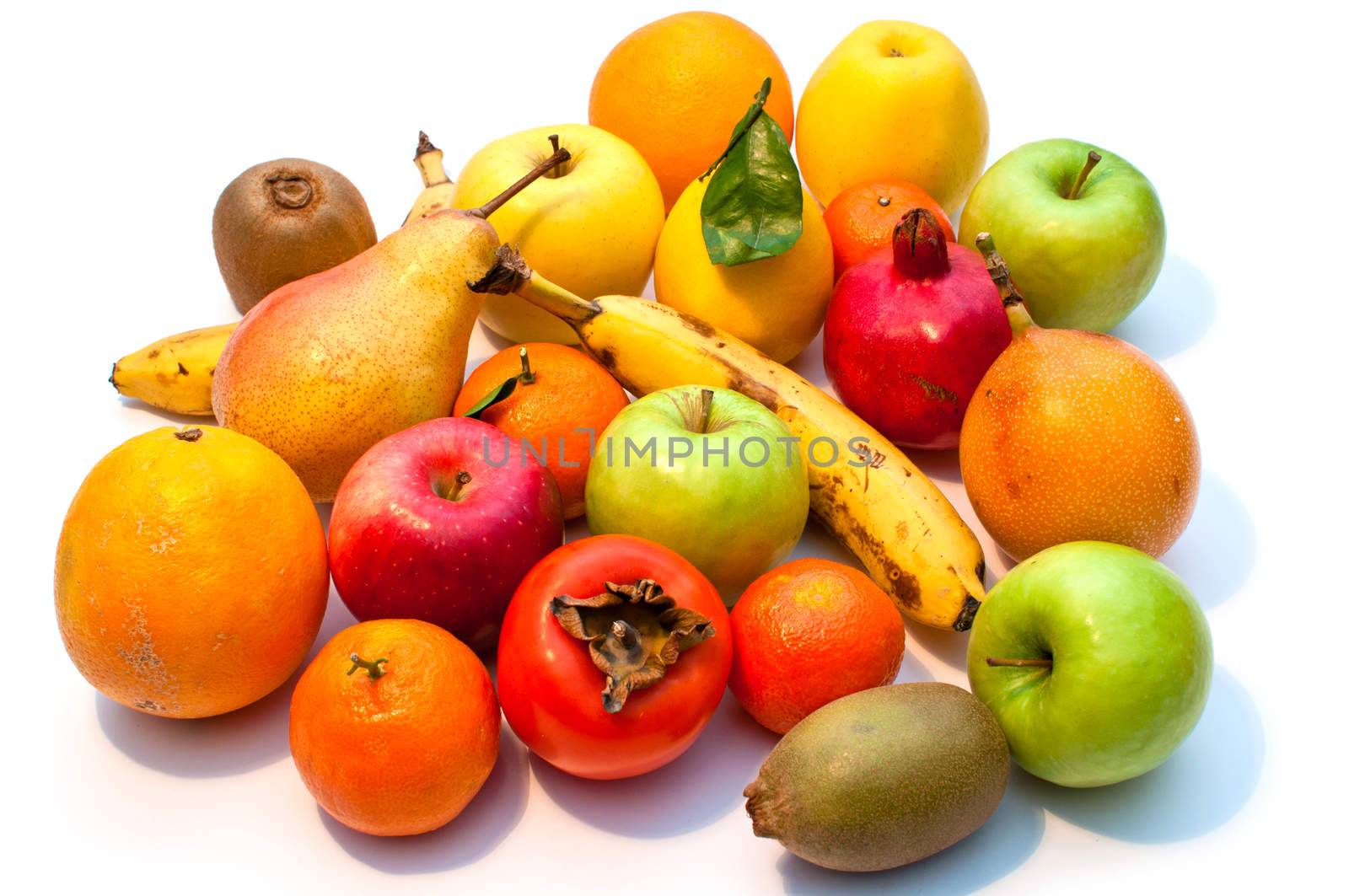 a lot of different fruits and green leaves on white background