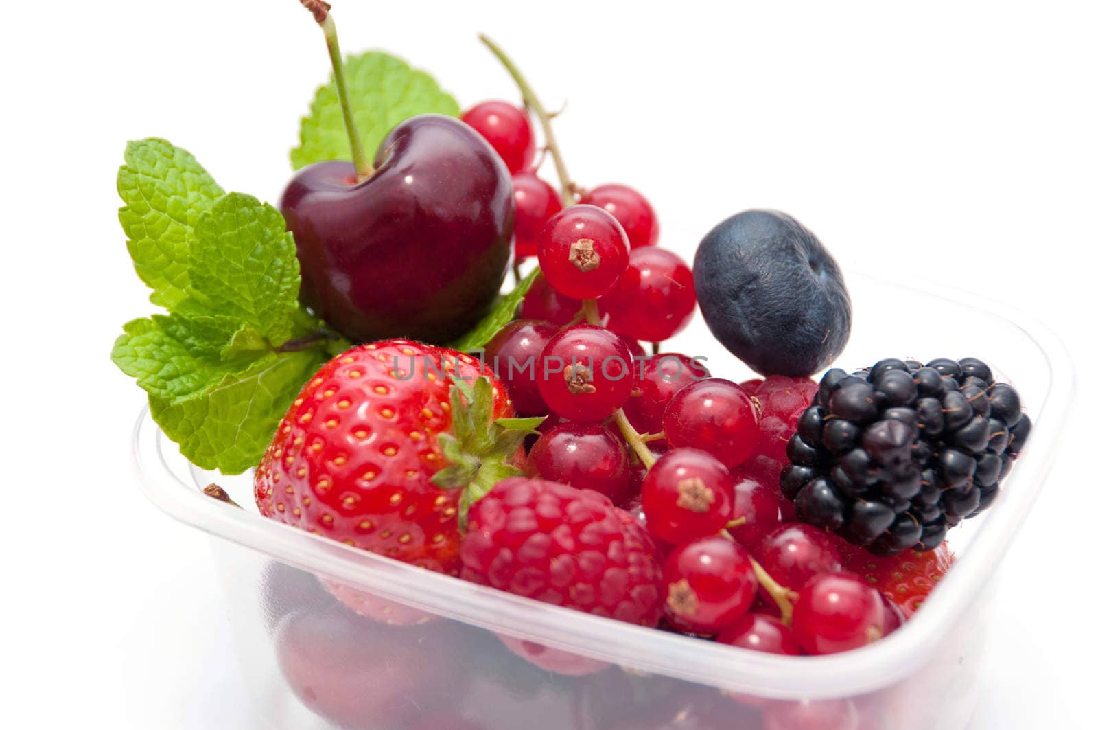 berries in a plastic box on a white background