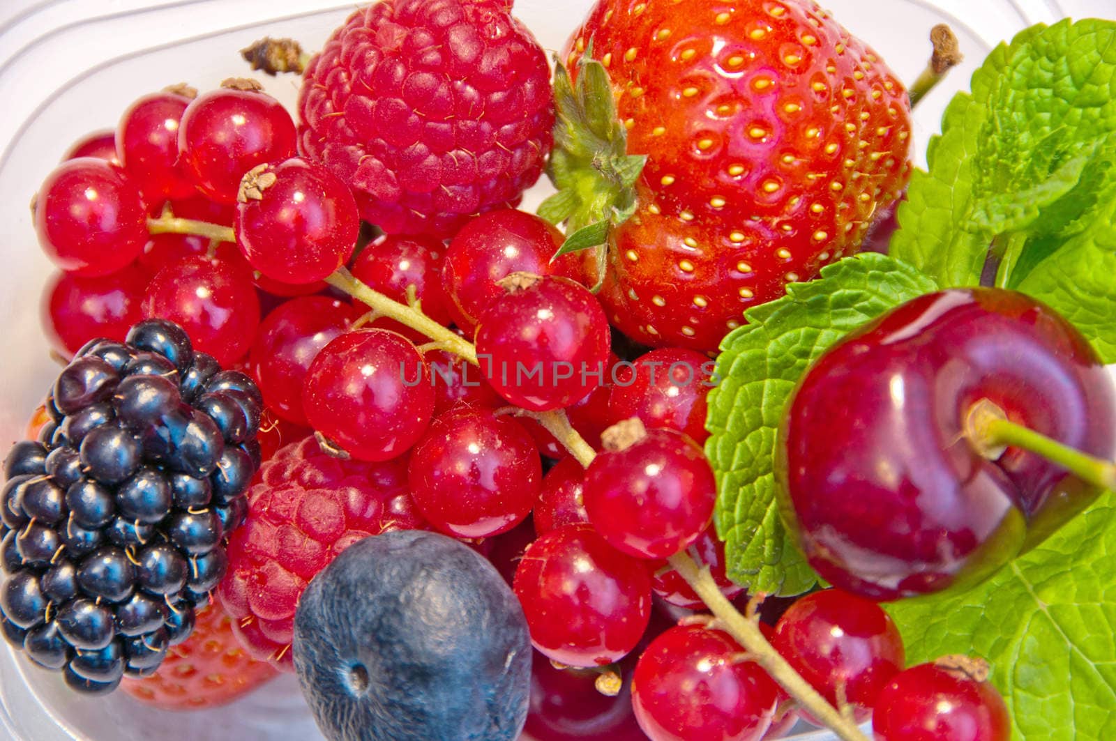 berries in a plastic box on a white background