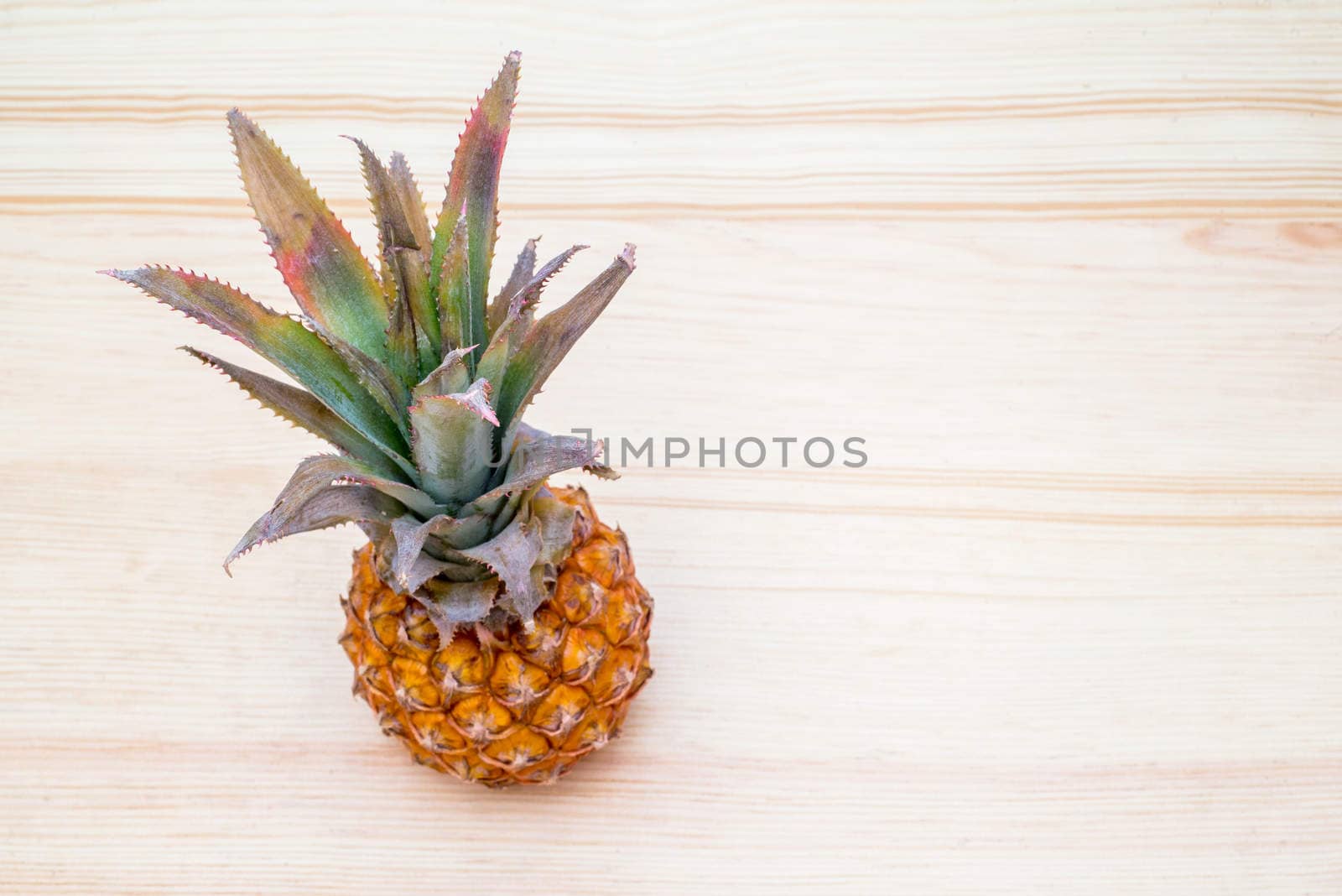 the fresh pineapple on the wooden table