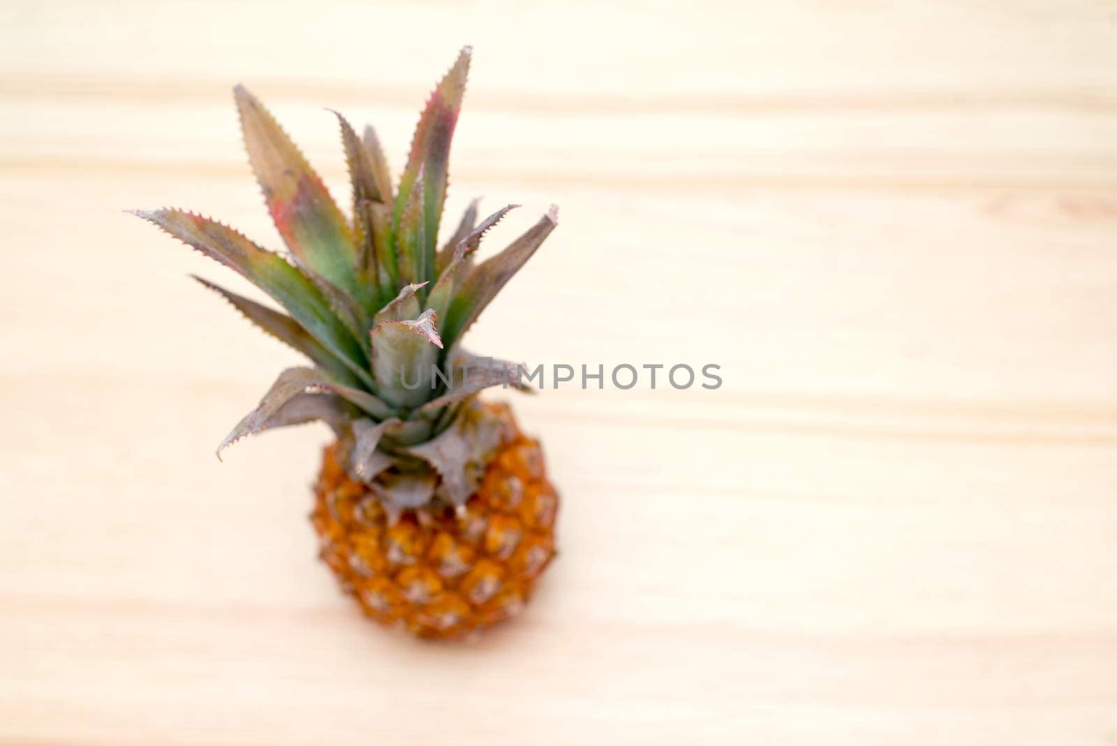 the fresh pineapple on the wooden table