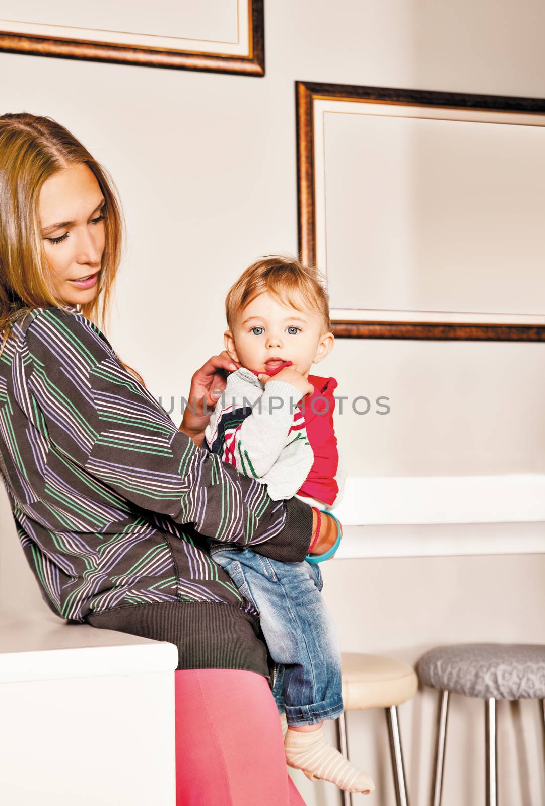 Young beautiful mother embracing her cute little boy with affection. Copy space frame.