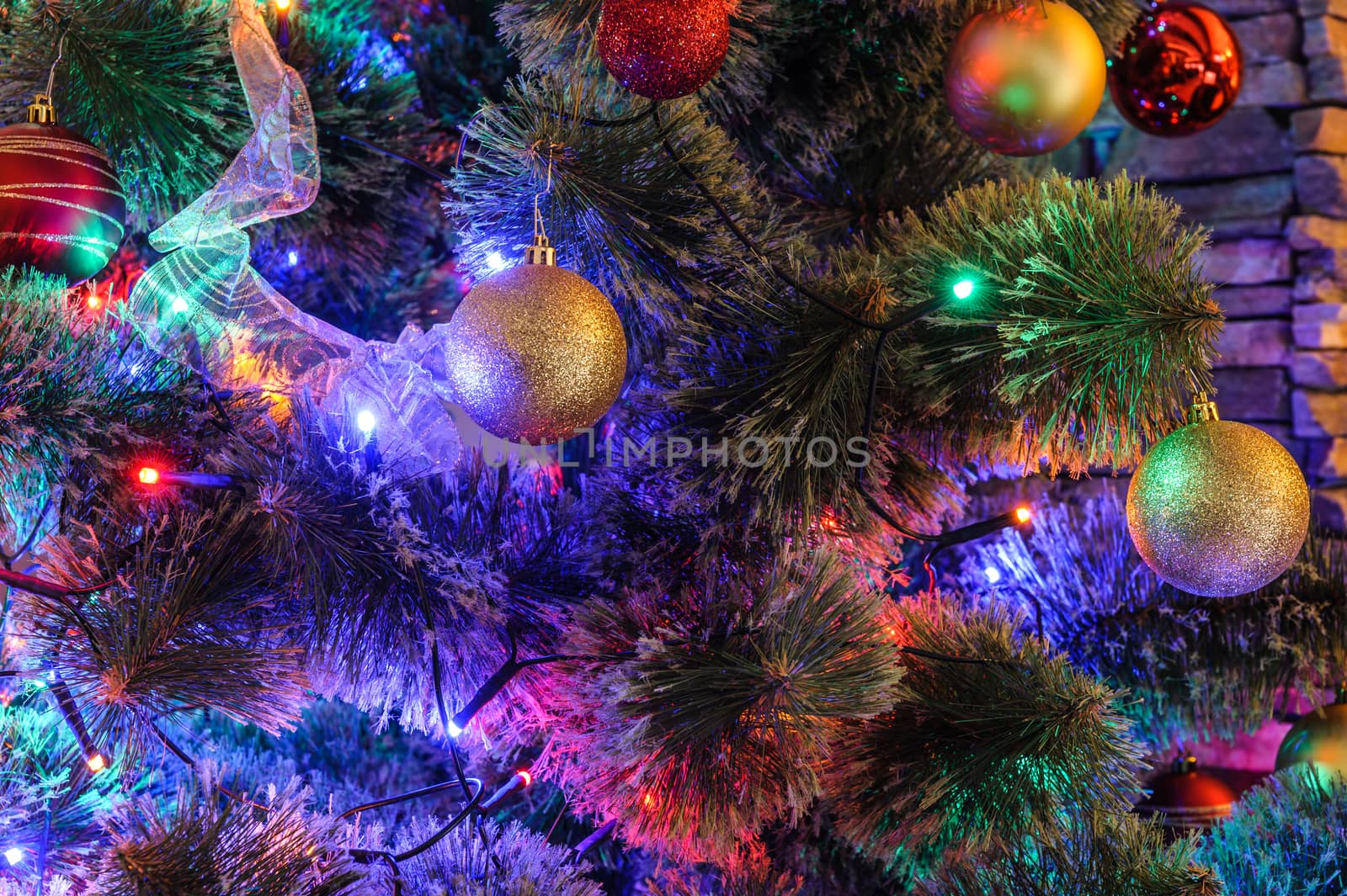 Decorated with balls and LED lights Christmas tree closeup, suitable as background