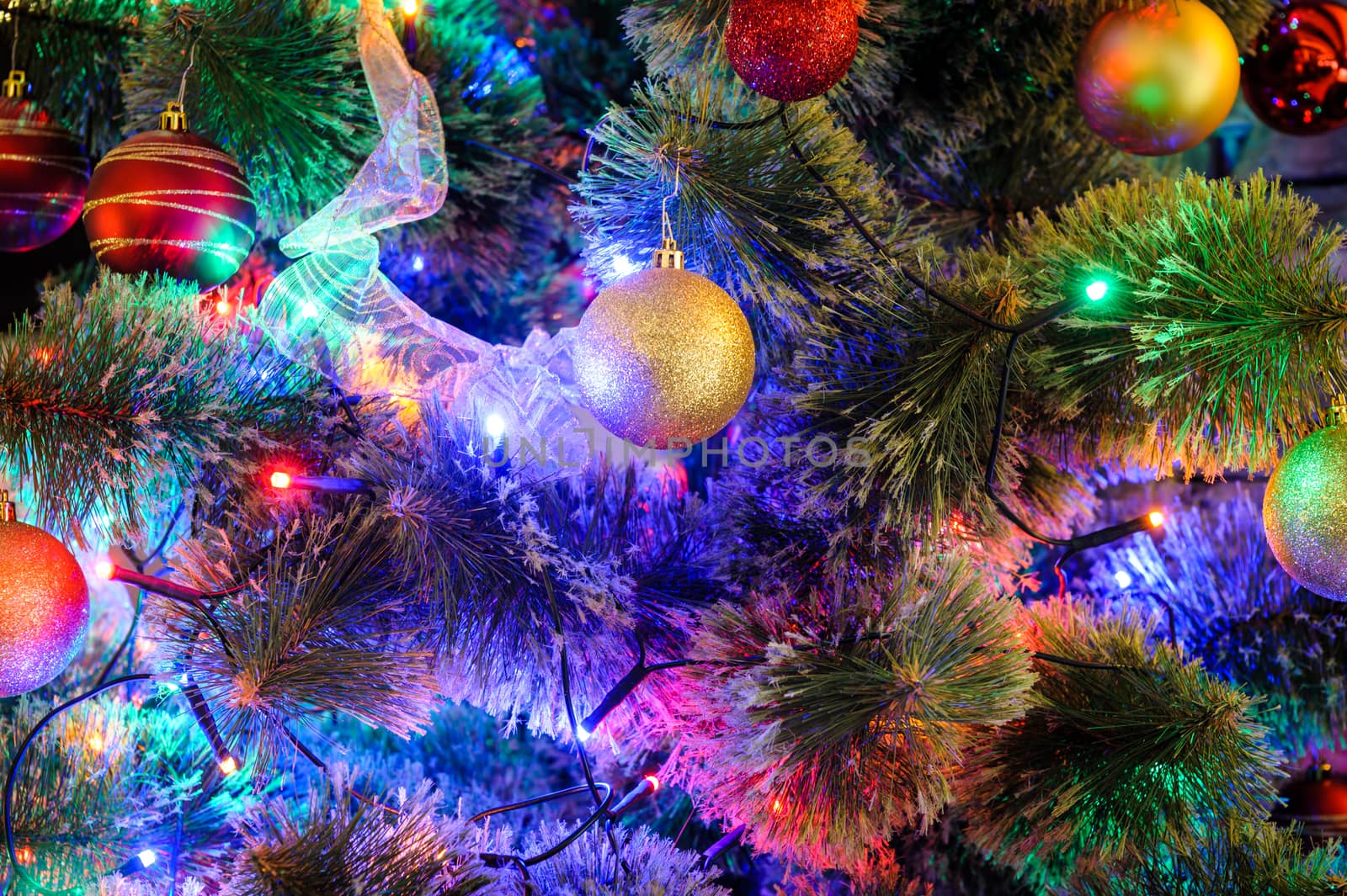 Decorated with balls and LED lights Christmas tree closeup, suitable as background