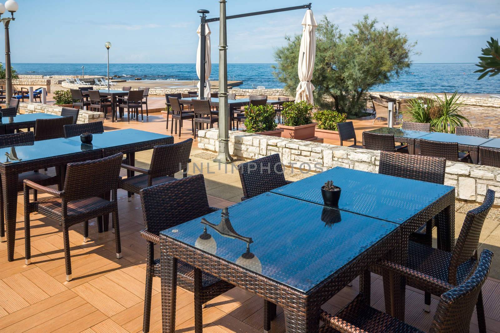 modern wicker furniture in a street restaurant on the seafront