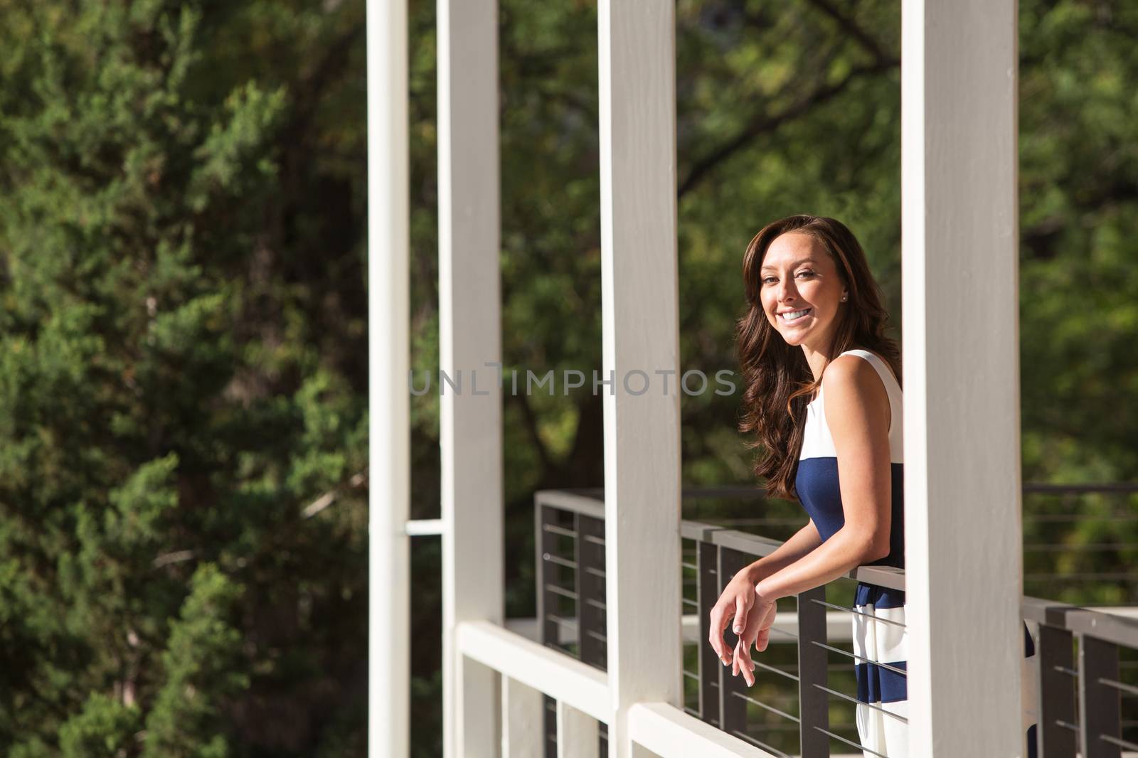 Single female adult standing on balcony outdoors