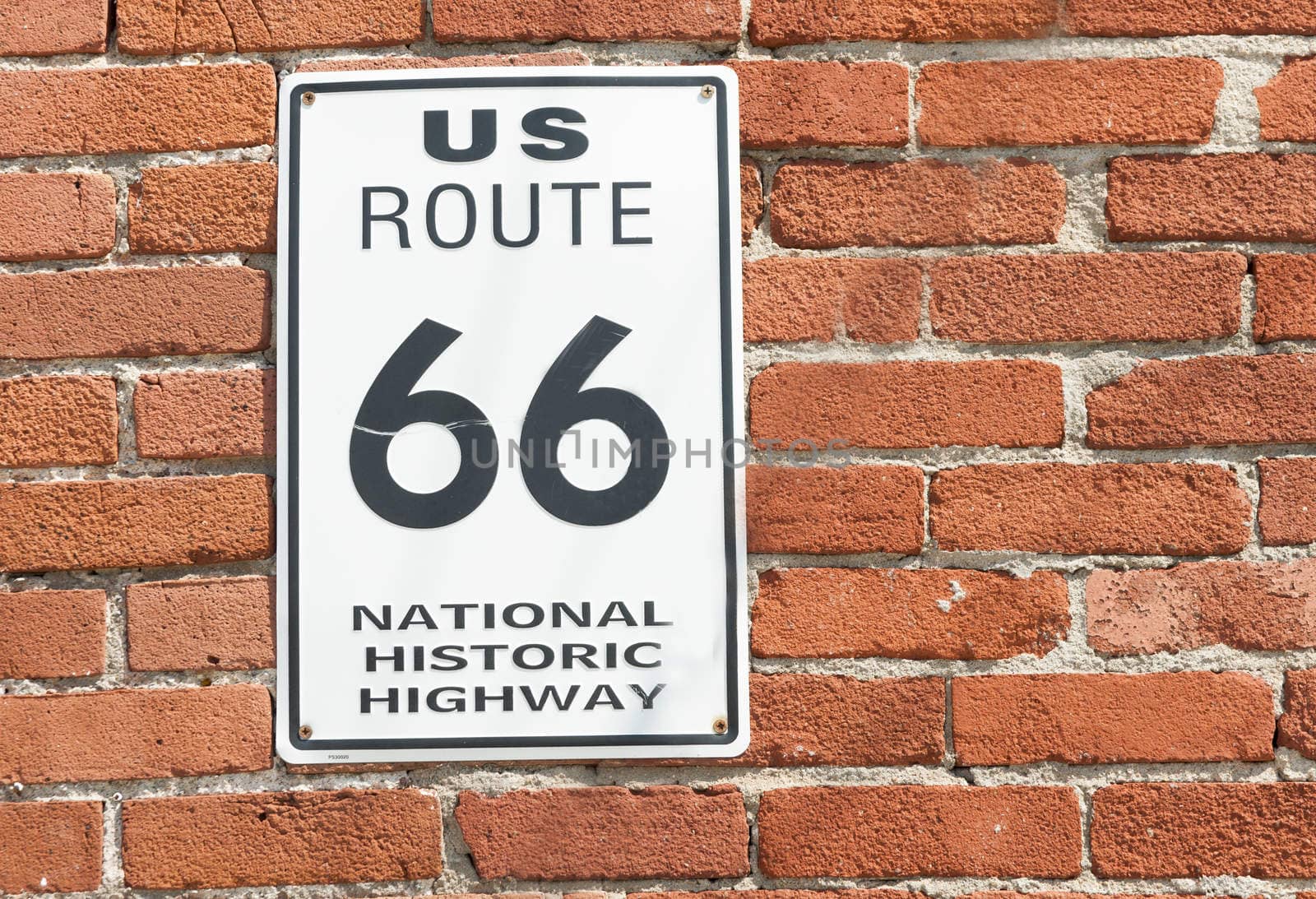US Route 66 National Historic Highway sign on red brick wall, Galena, Kansas, USA