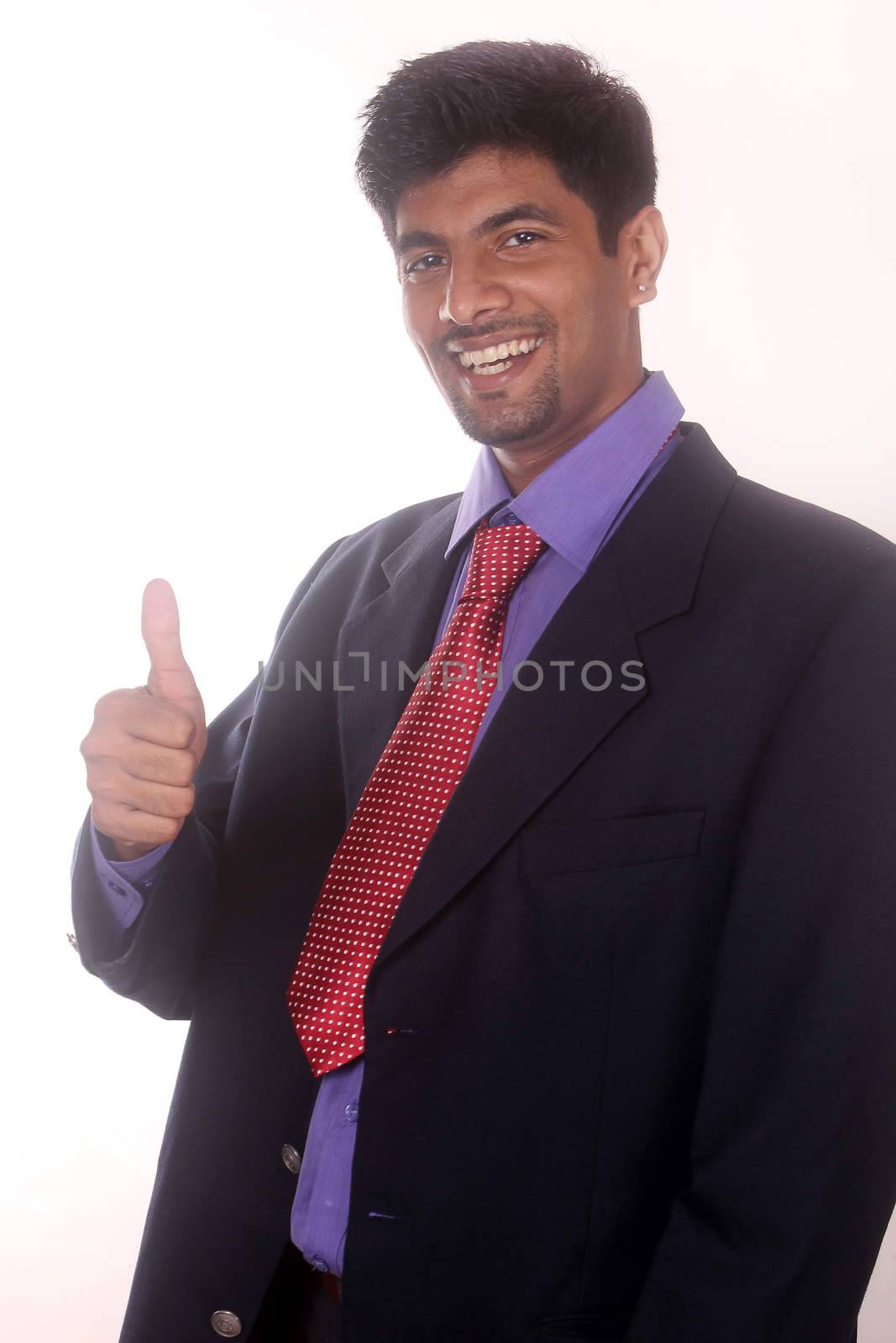 Smiling businessman with thumb up by ajithpride