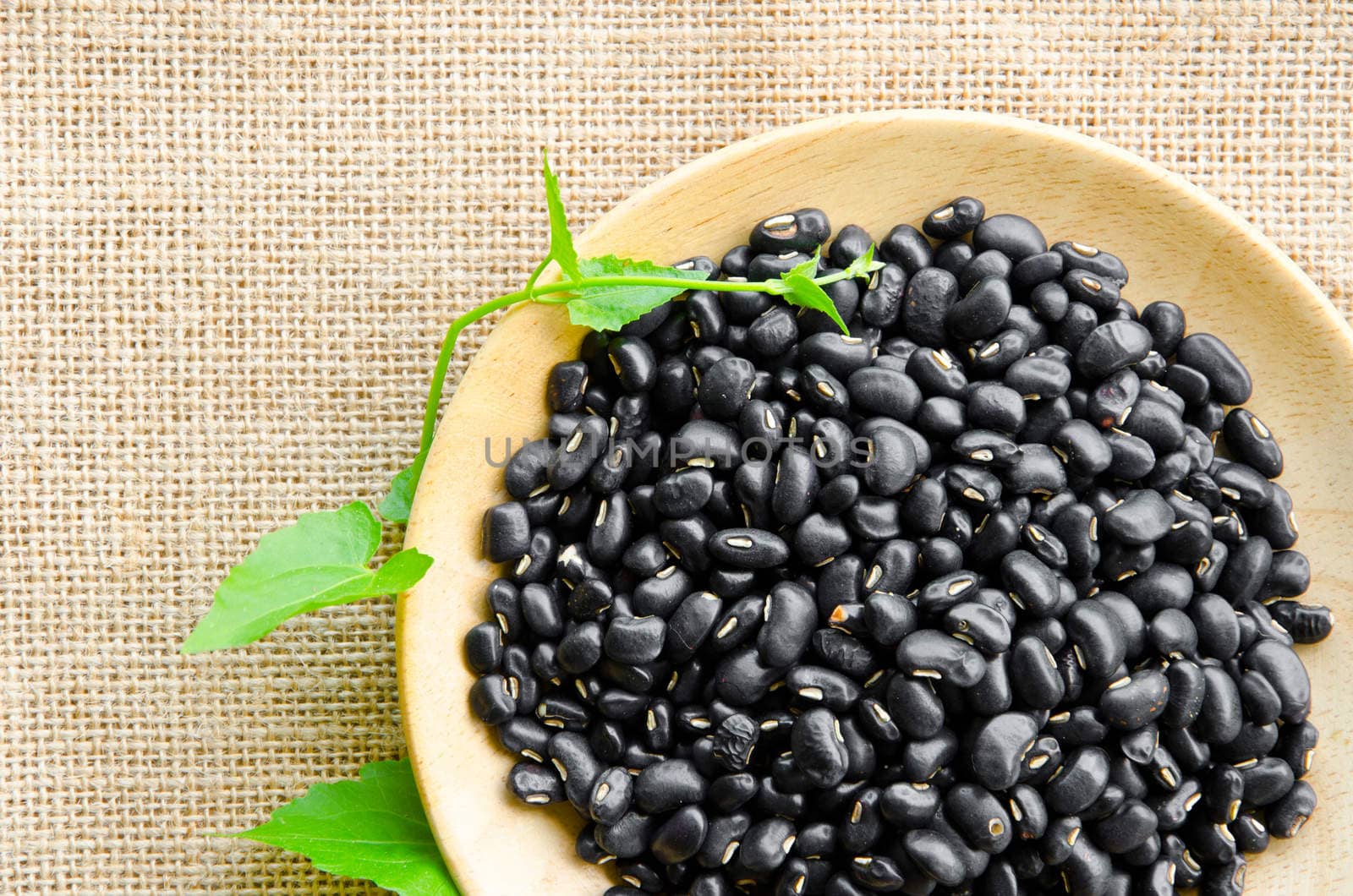 Black Eyed Peas and leaf on sack background