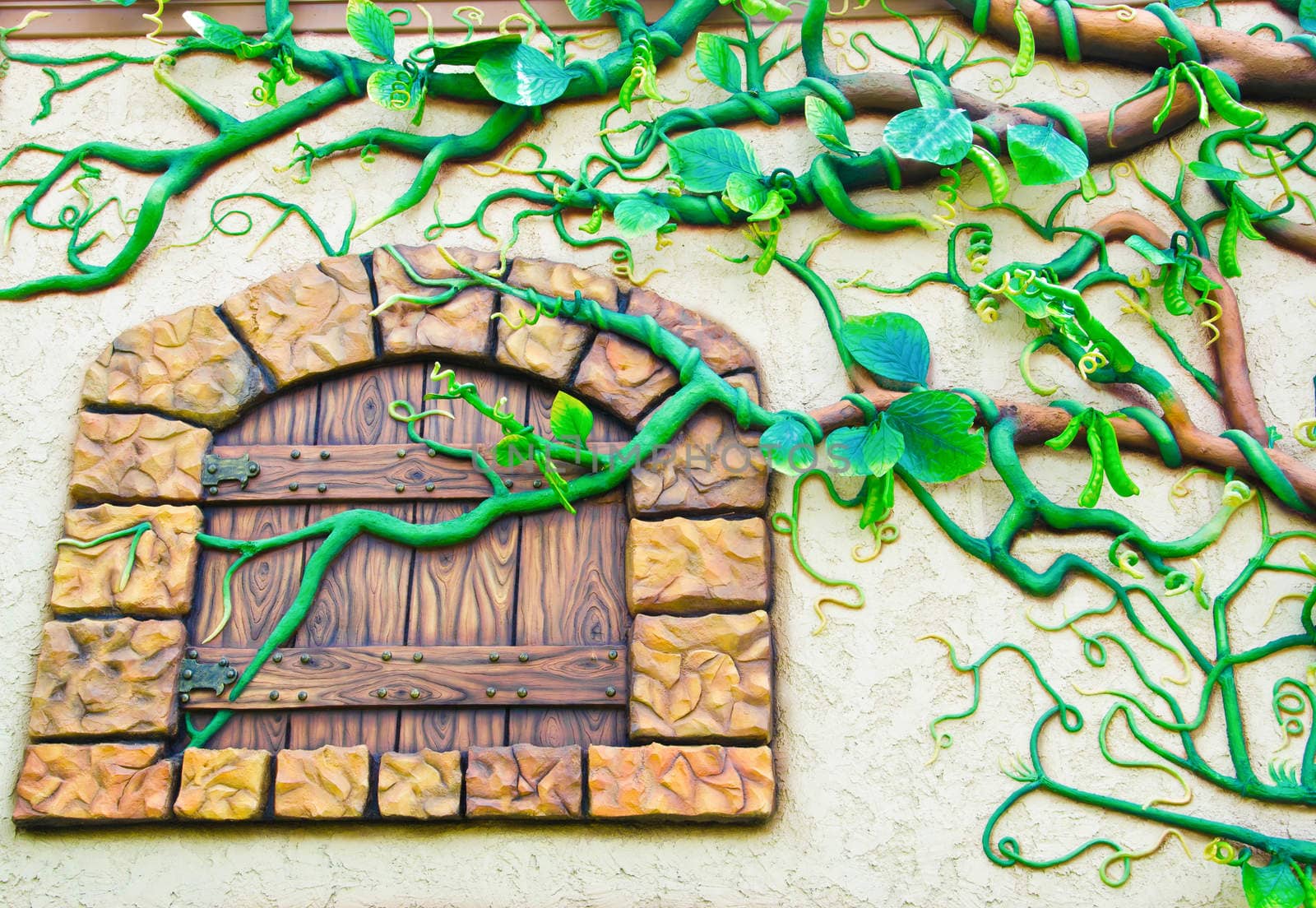 Low relief cement of tree on wall and window