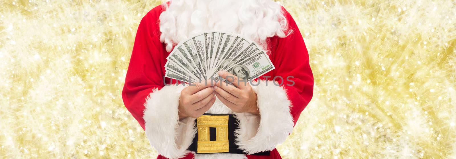 close up of santa claus with dollar money by dolgachov