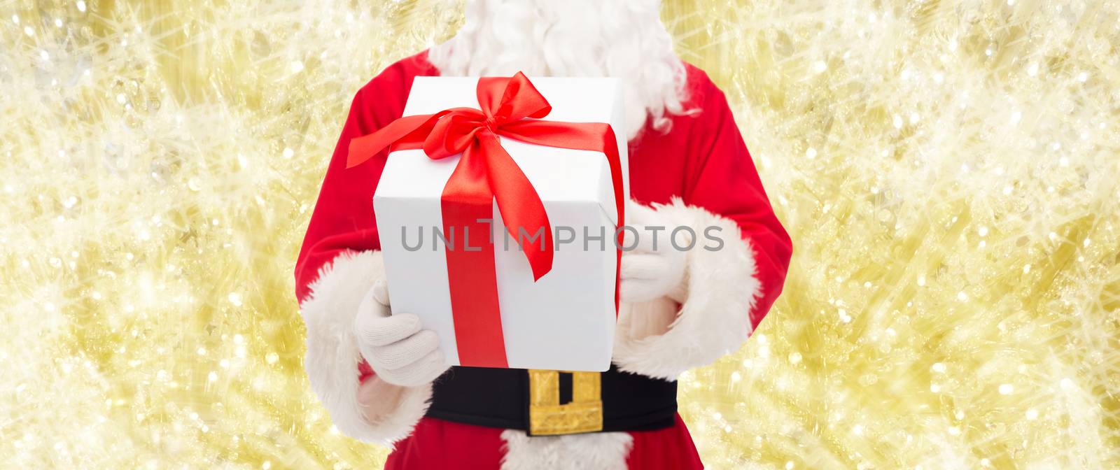 man in costume of santa claus with gift box by dolgachov