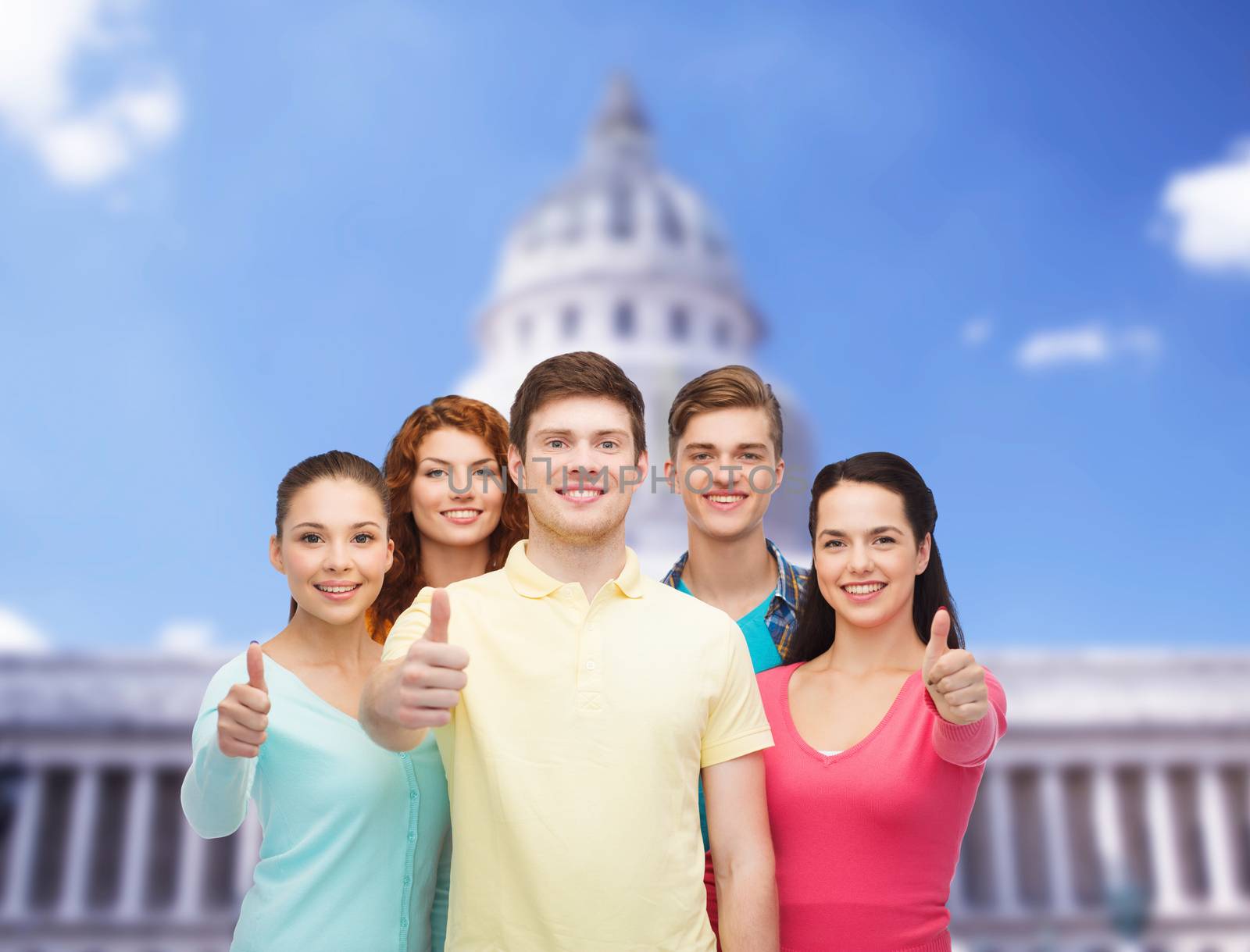 group of smiling teenagers showing ok sign by dolgachov