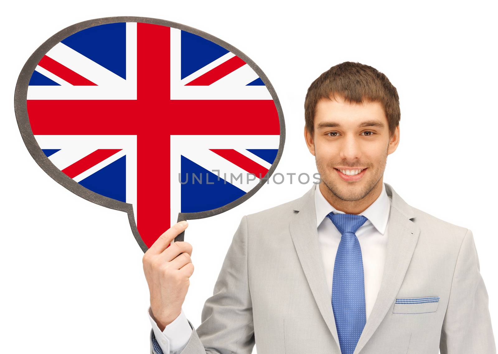 education, foreign language, english, people and communication concept - smiling young man or businessman in tie and suit holding text bubble of british flag