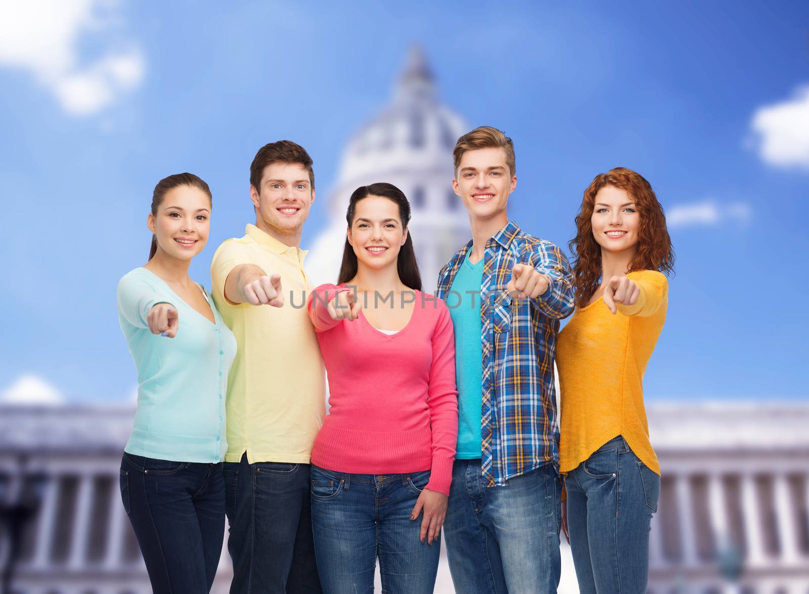 friendship, tourism, travel and people concept - group of smiling teenagers standing over white house background