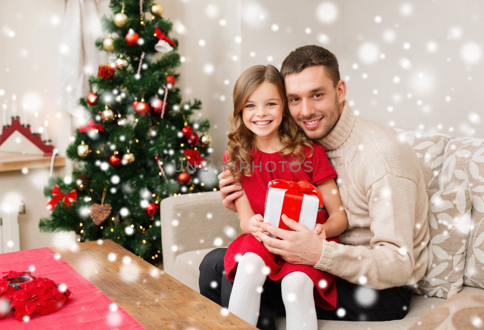 smiling father and daughter holding gift box by dolgachov