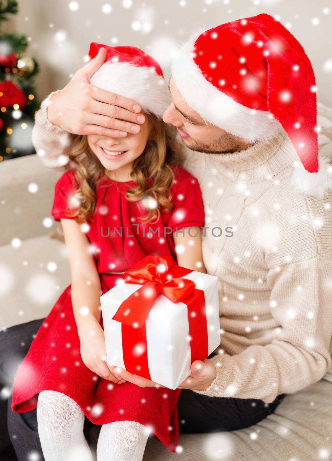 smiling father and daughter holding gift box by dolgachov