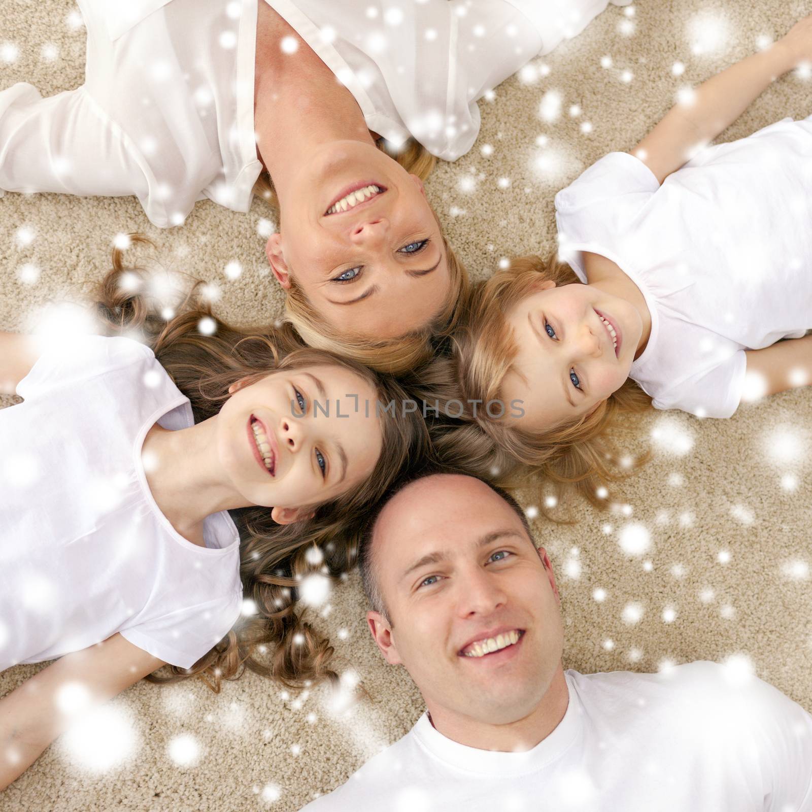 family, children and home concept - smiling family with and two little girls lying in circle on floor at home