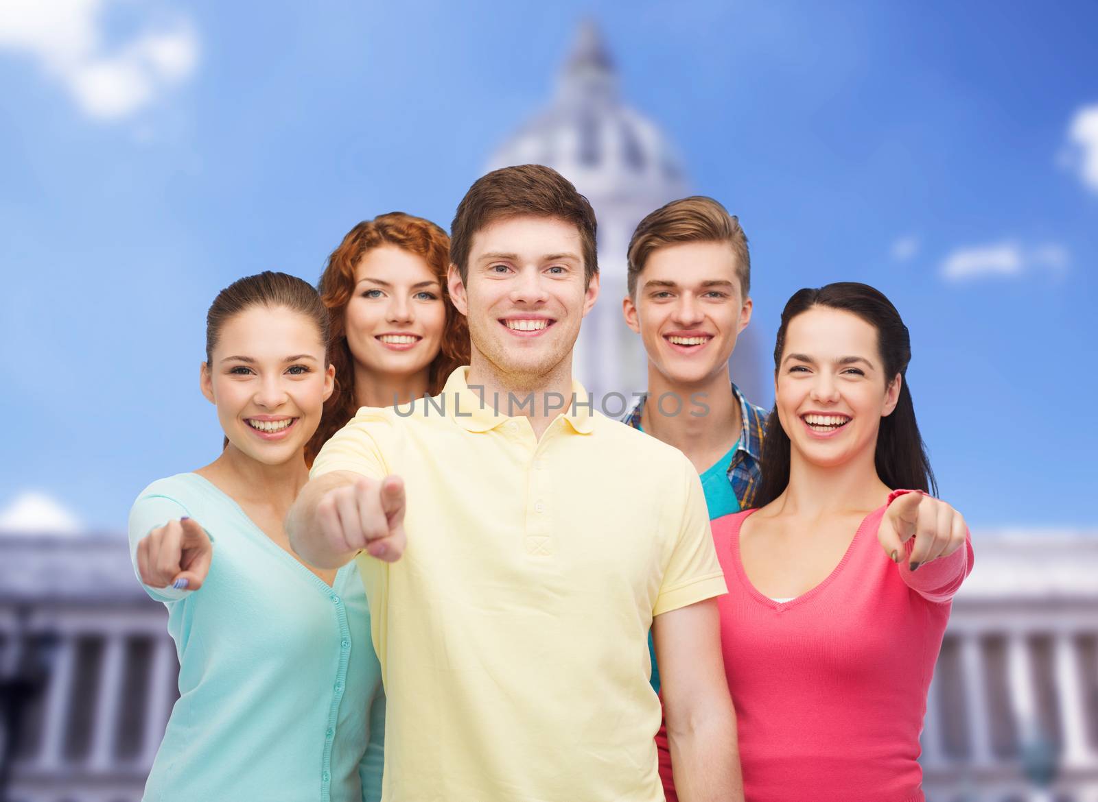 friendship, tourism, travel and people concept - group of smiling teenagers standing over white house background