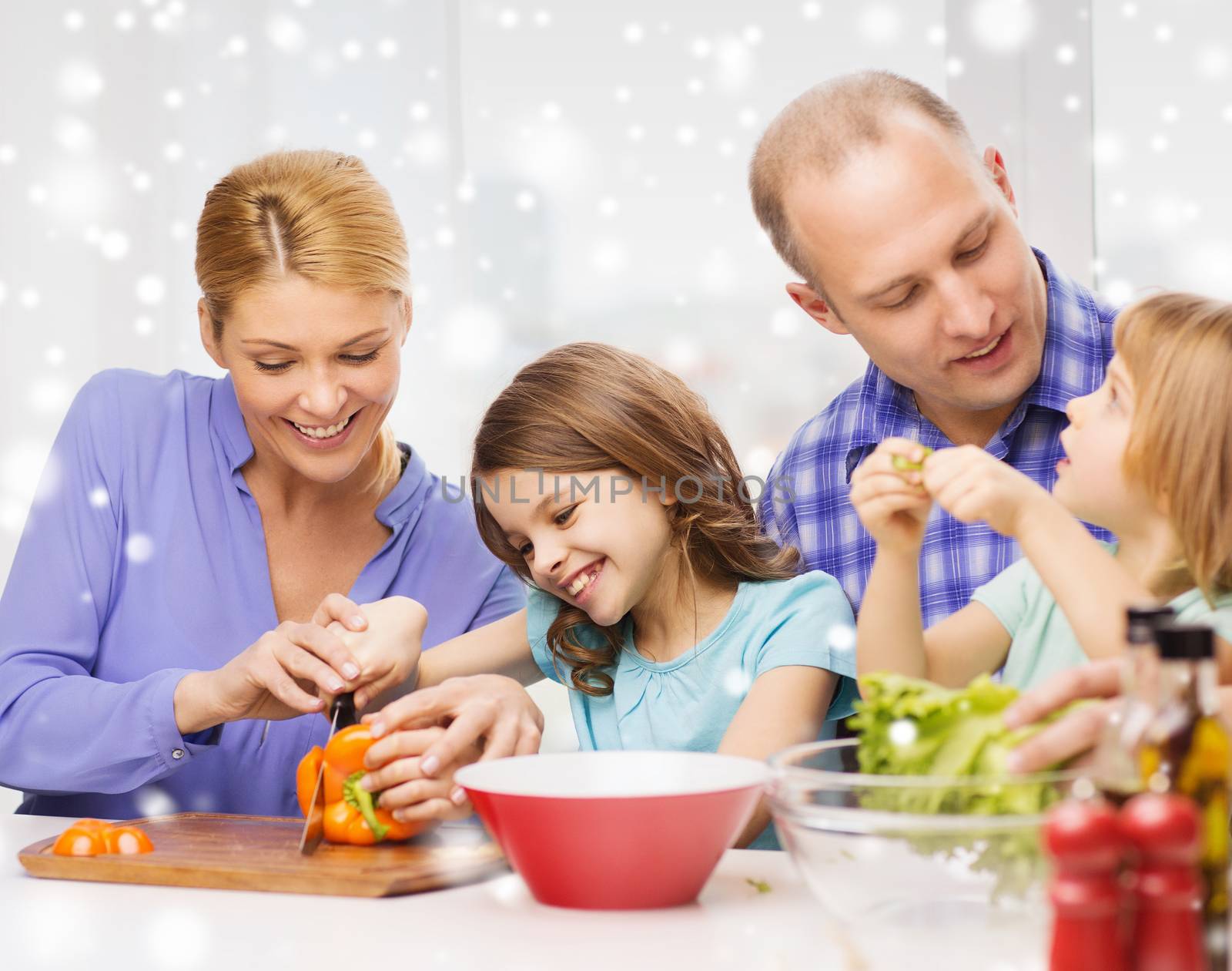 happy family with two kids making dinner at home by dolgachov