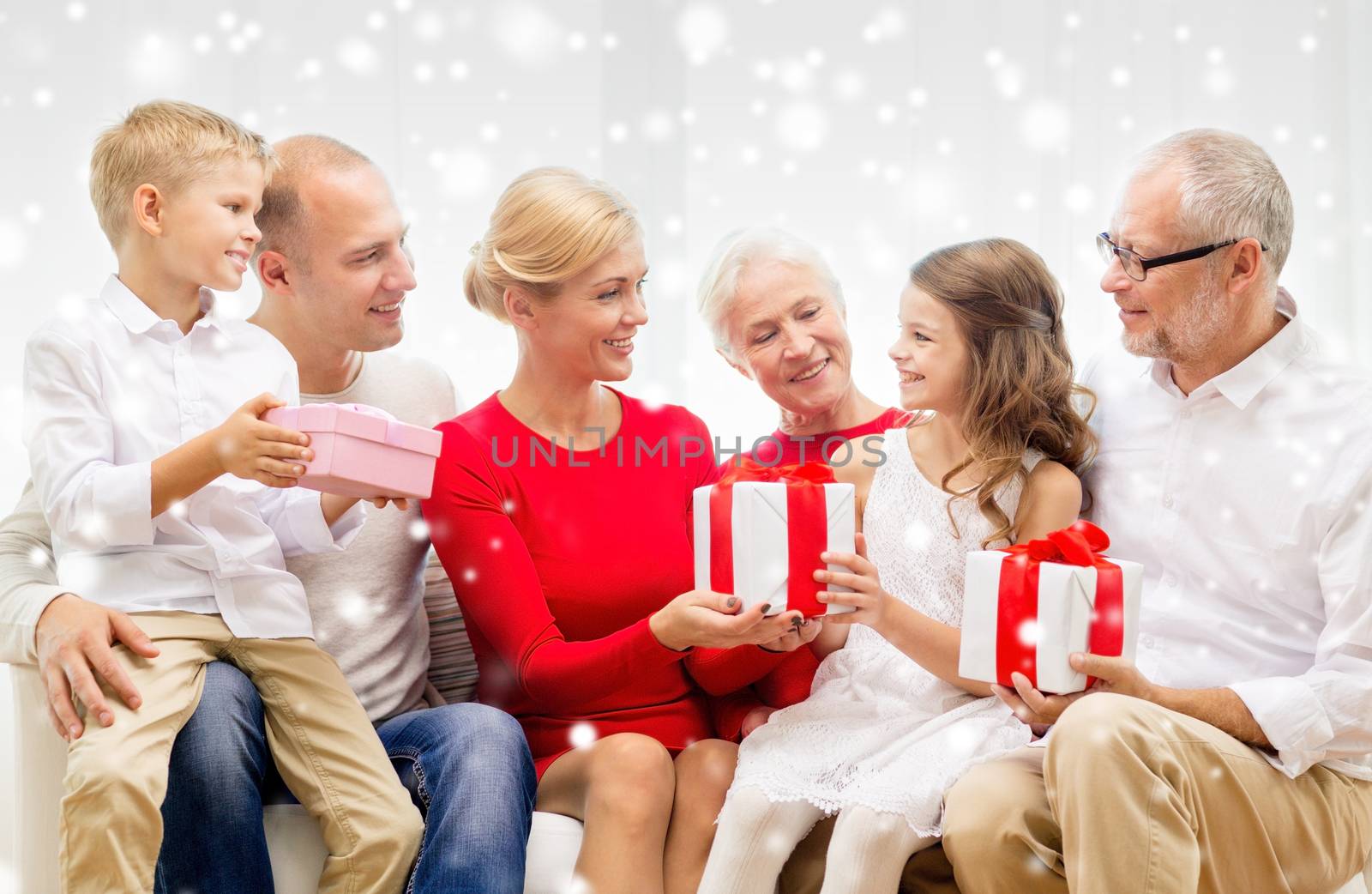 smiling family with gifts at home by dolgachov