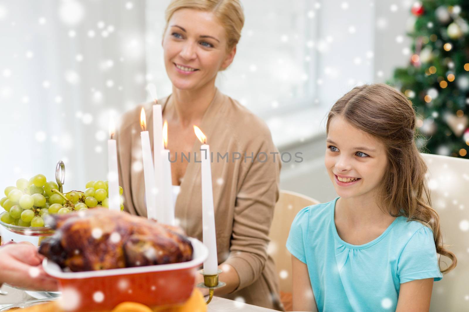 smiling family having holiday dinner at home by dolgachov