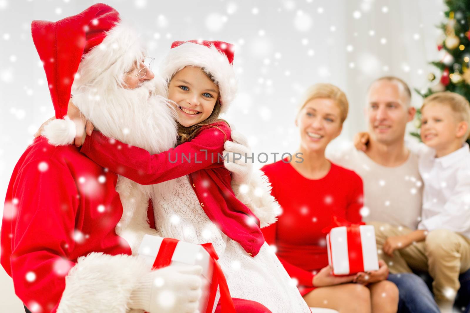 family, holidays, generation, christmas and people concept - smiling family with santa claus and gift boxes at home