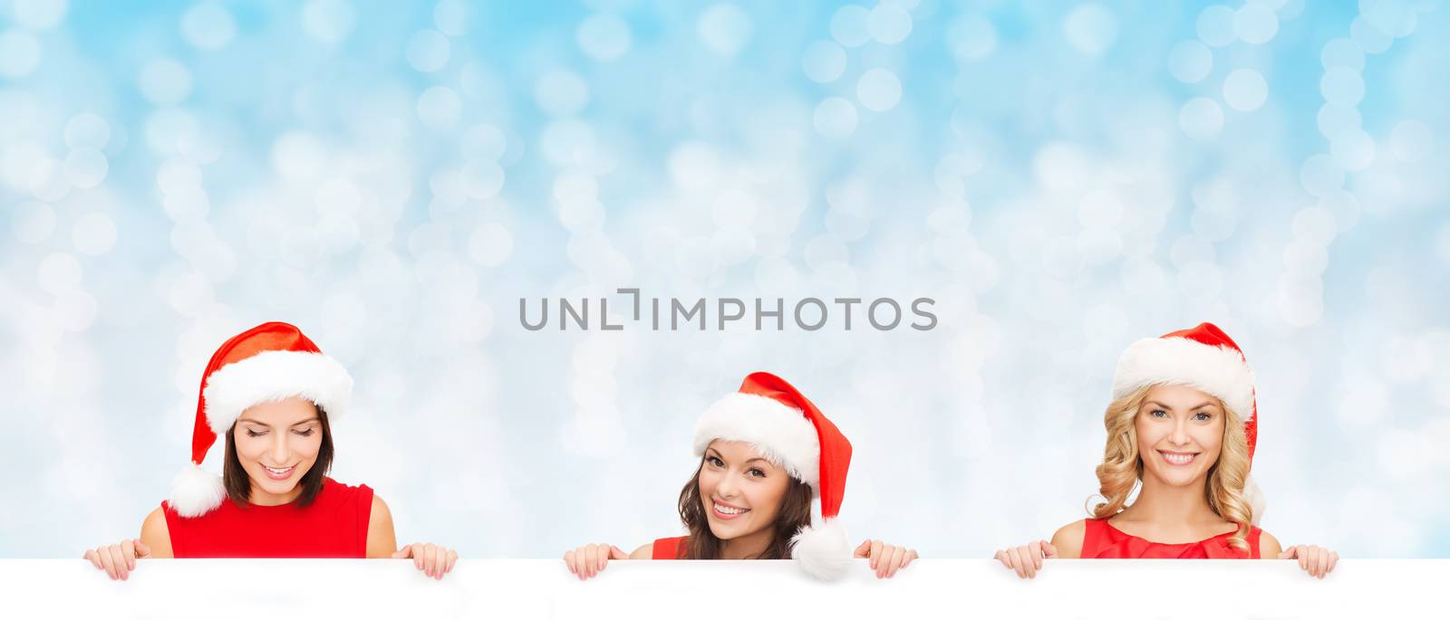 women in santa helper hat with blank white board by dolgachov