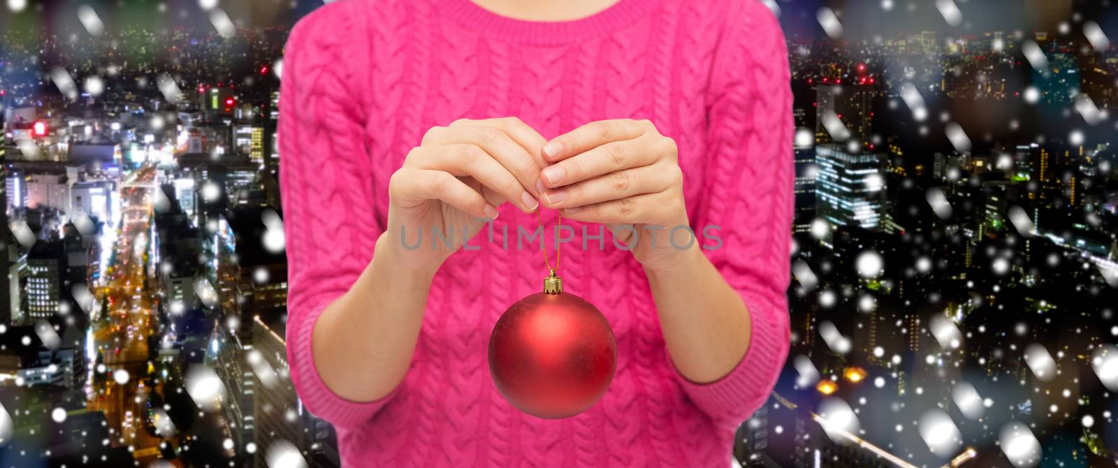 close up of woman in sweater with christmas ball by dolgachov