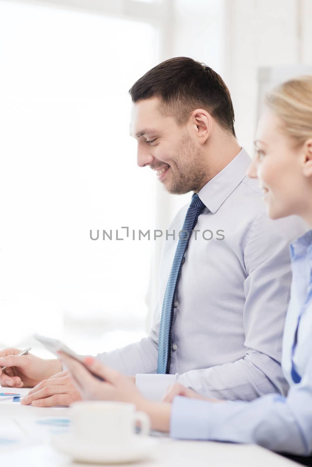 smiling businessman working in office by dolgachov