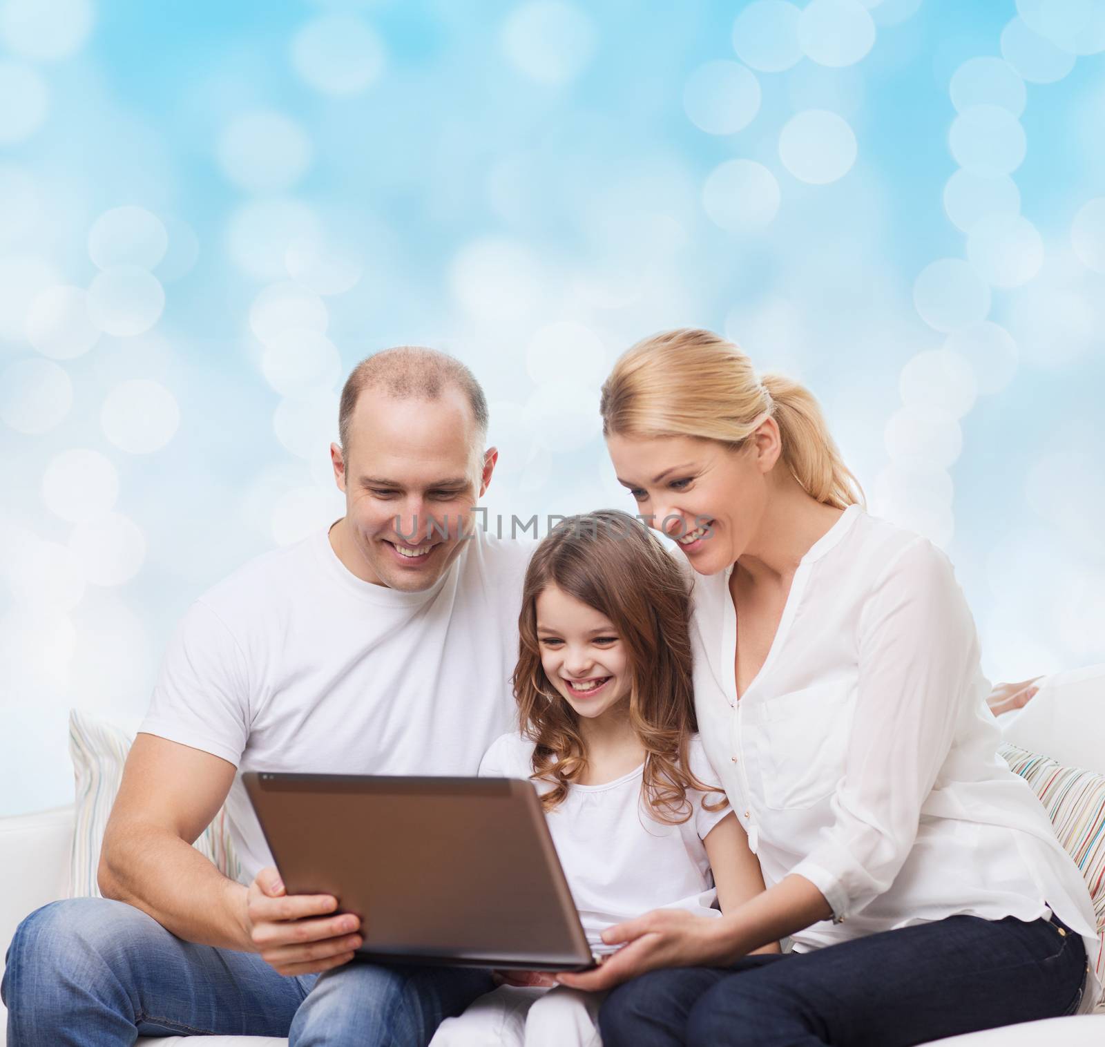 smiling family with laptop by dolgachov