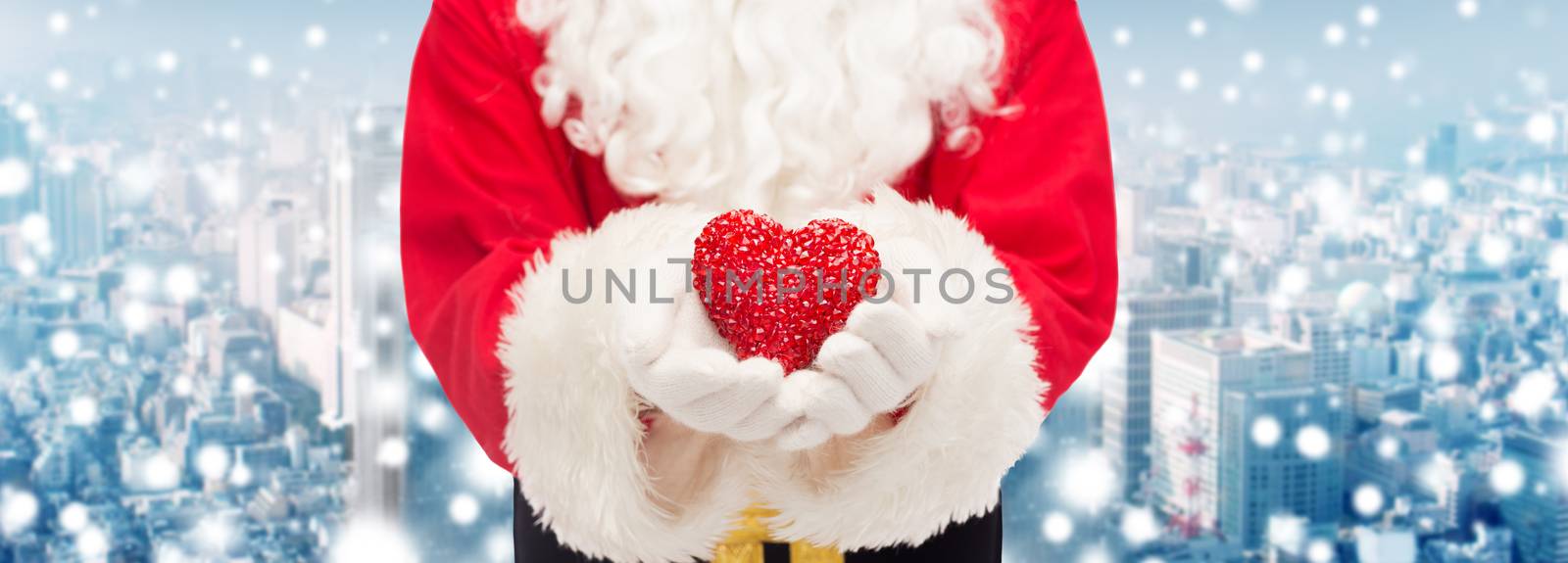 christmas, holidays, love, charity and people concept - close up of santa claus with heart shape decoration over snowy city background