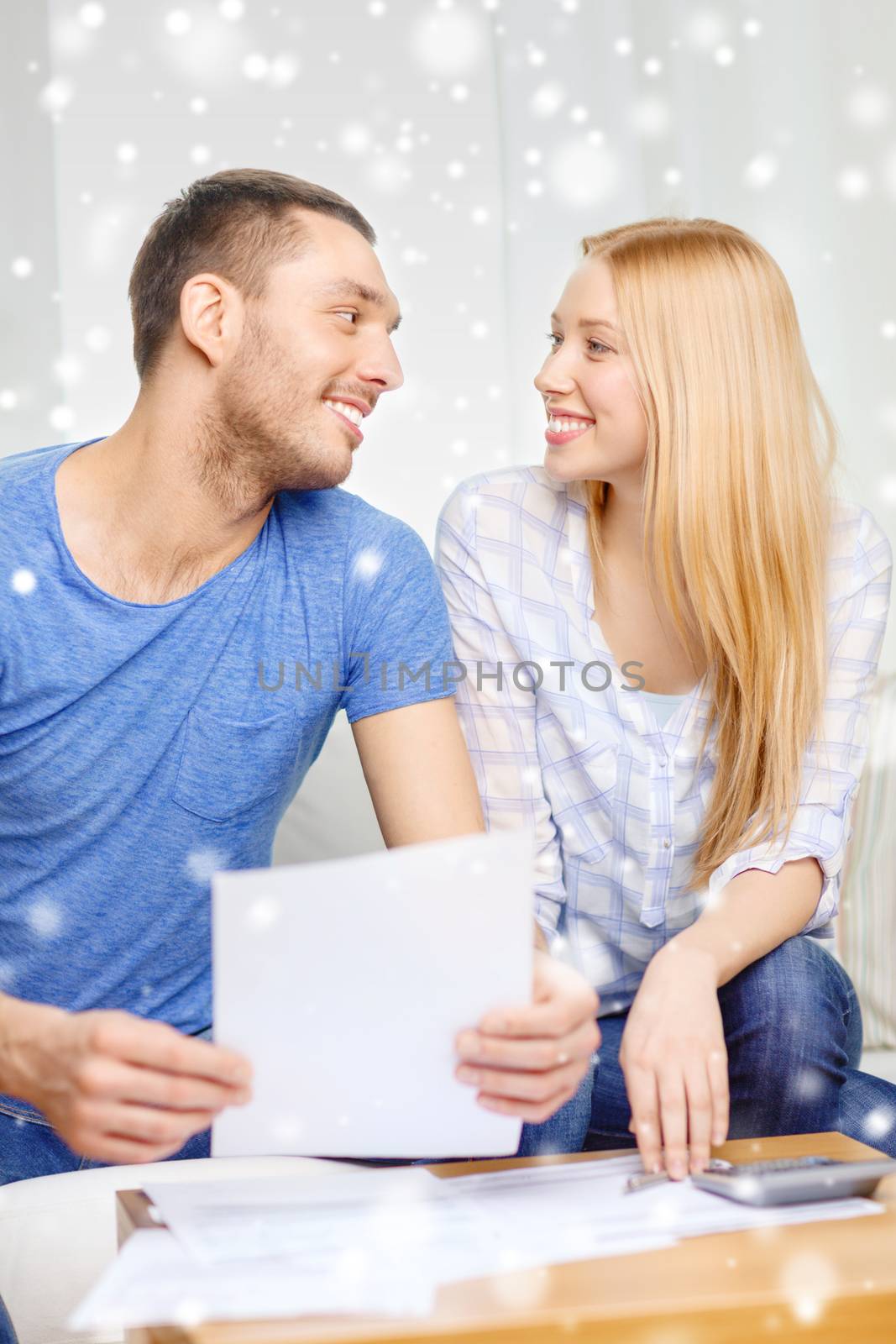 happy couple with papers and calculator at home by dolgachov