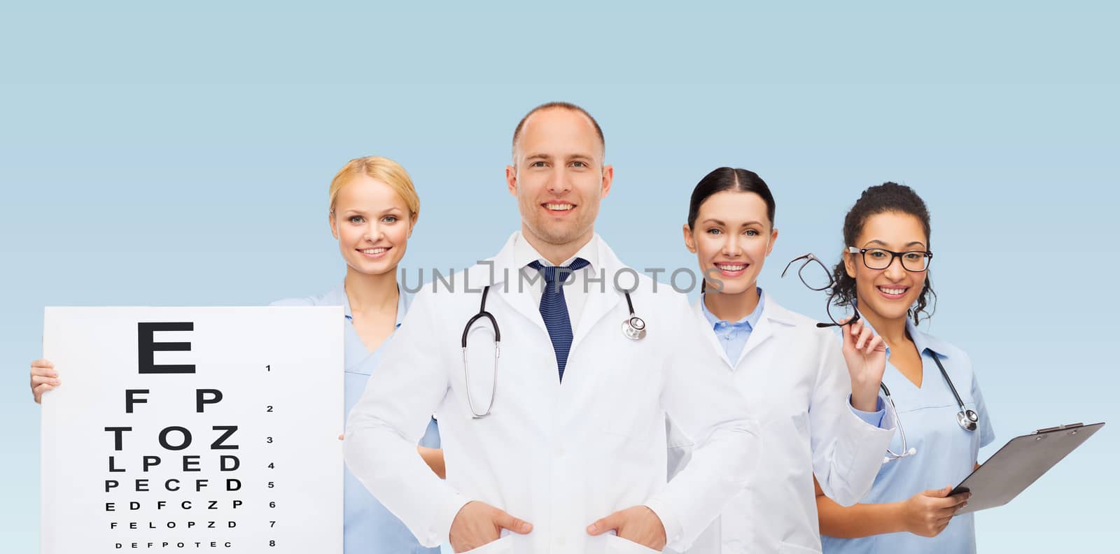 medicine, profession, teamwork and healthcare concept - international group of smiling medics or doctors with eye chart, clipboard and stethoscopes over blue background