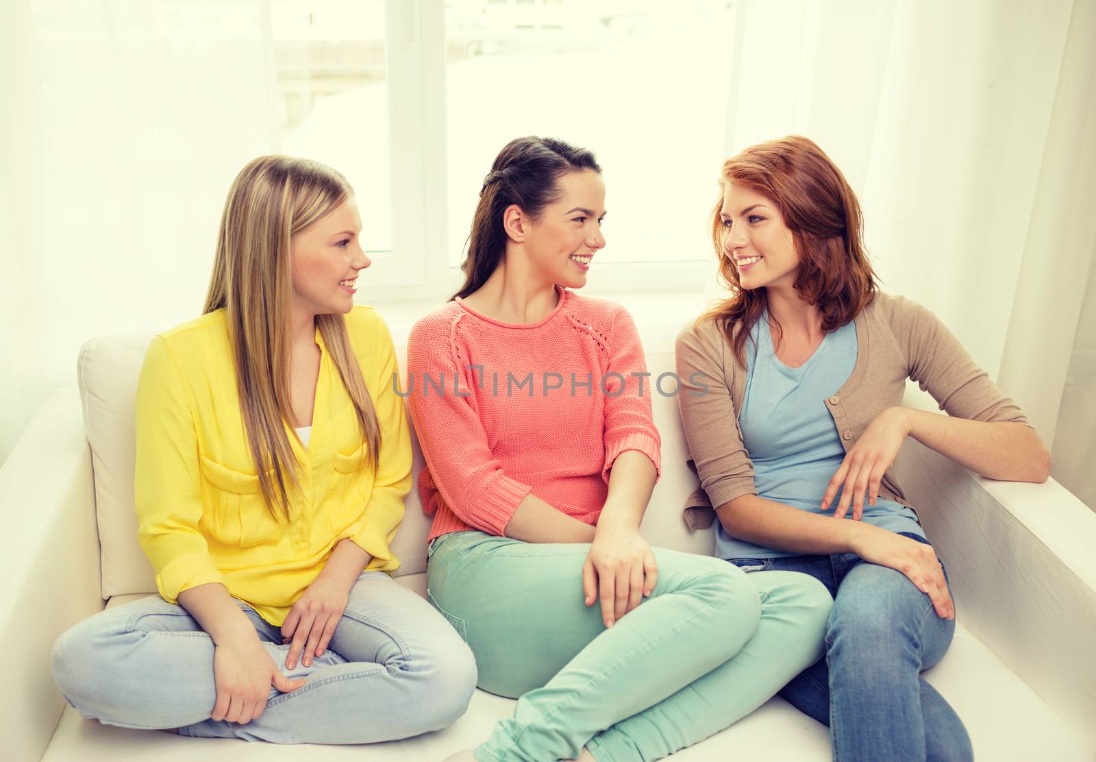 three girlfriends having a talk at home by dolgachov