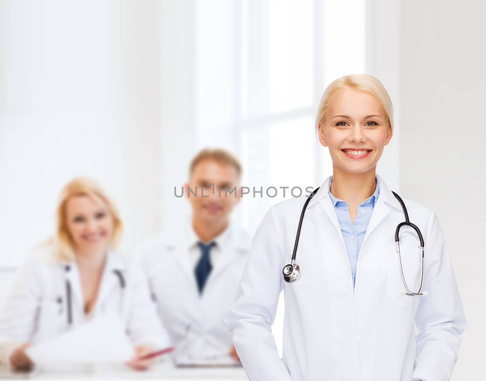 smiling female doctor with stethoscope by dolgachov