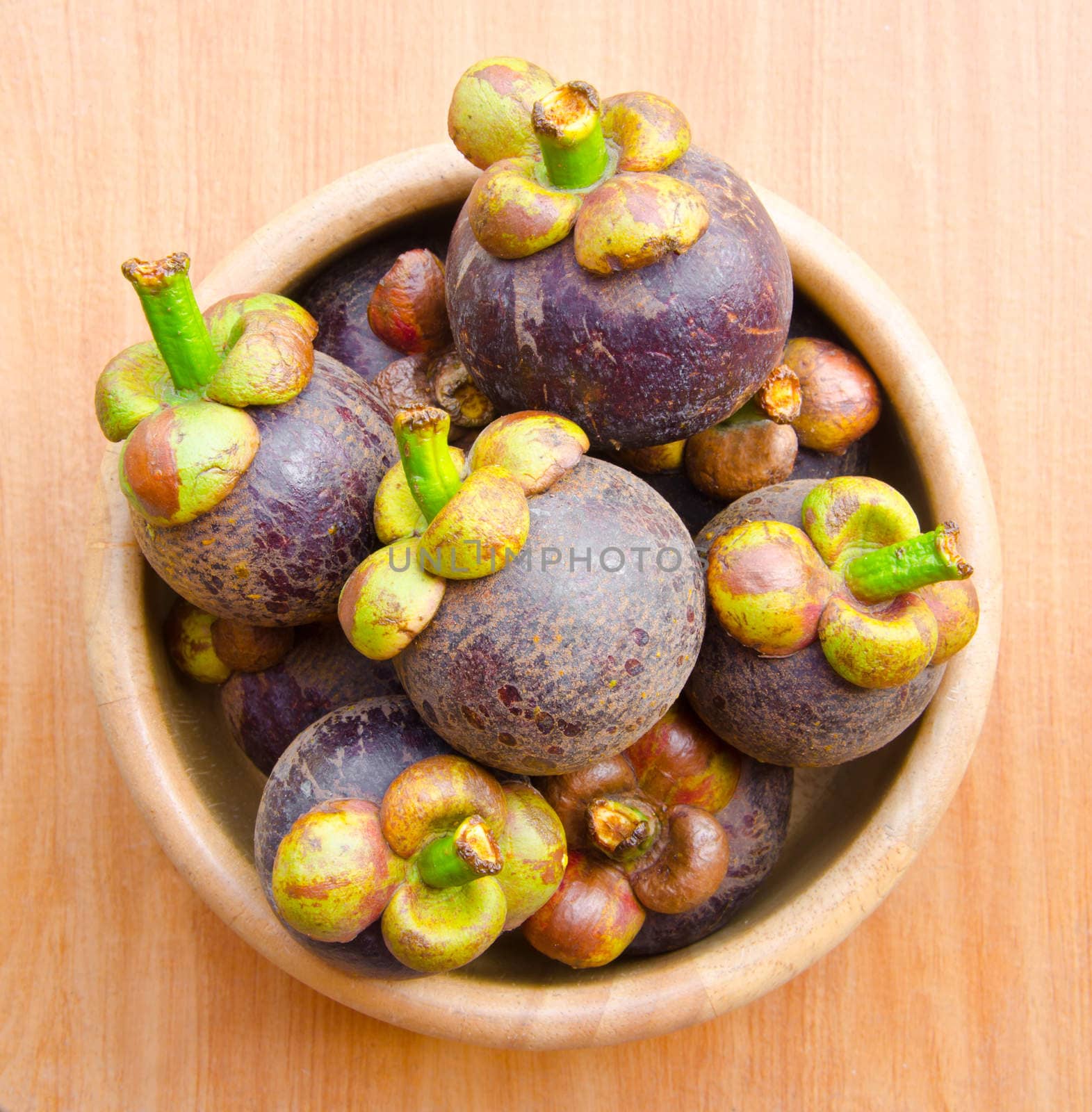 Mangosteen in bowl wooden on wooden background, Queen of fruit.