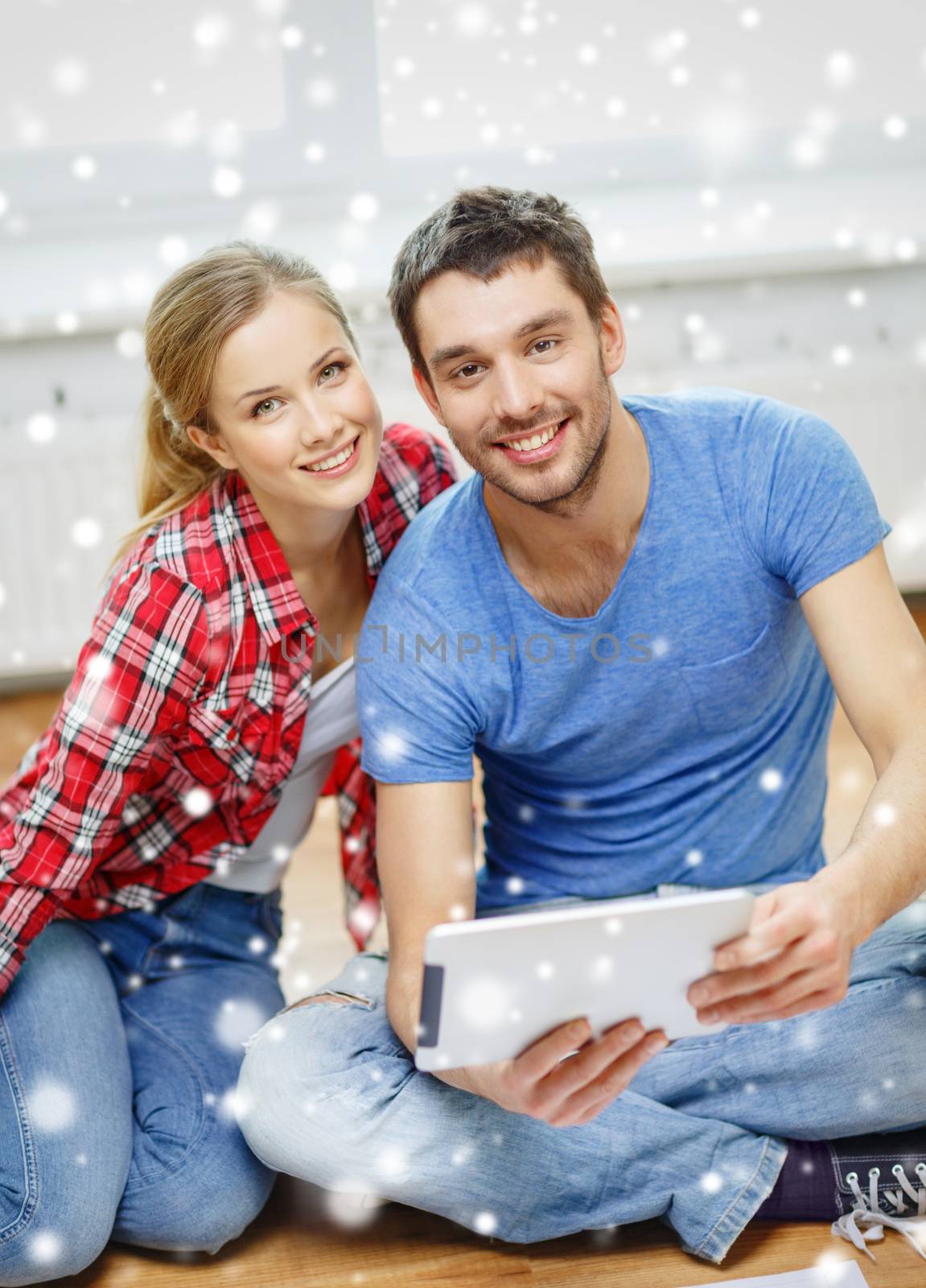 smiling couple with tablet pc at home by dolgachov