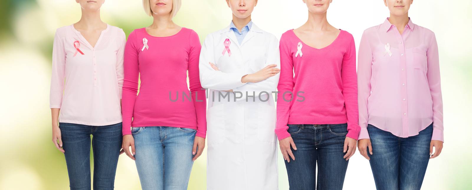 healthcare, people and medicine concept - close up of women in blank shirts with pink breast cancer awareness ribbons over white background