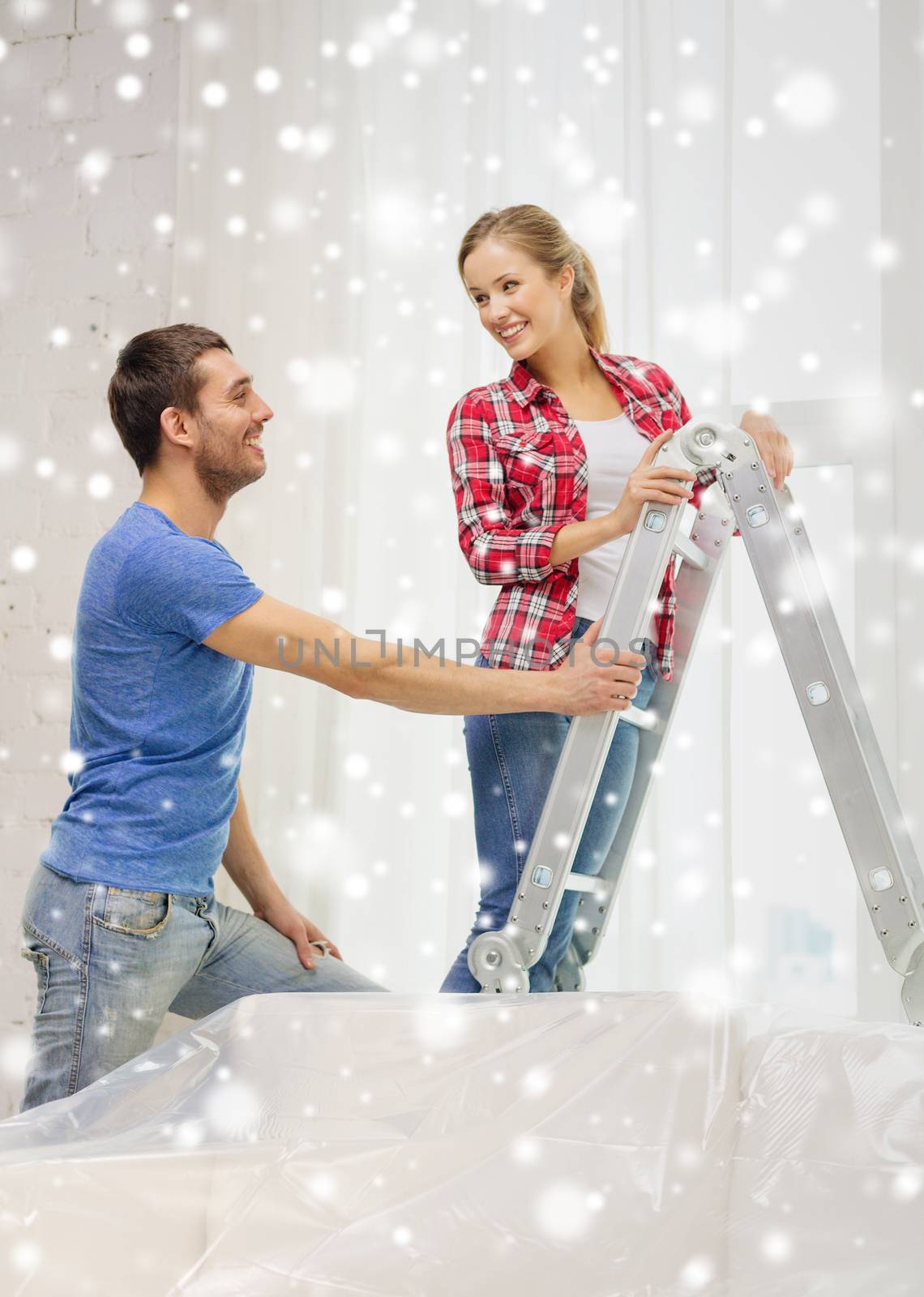 smiling couple with ladder at home by dolgachov